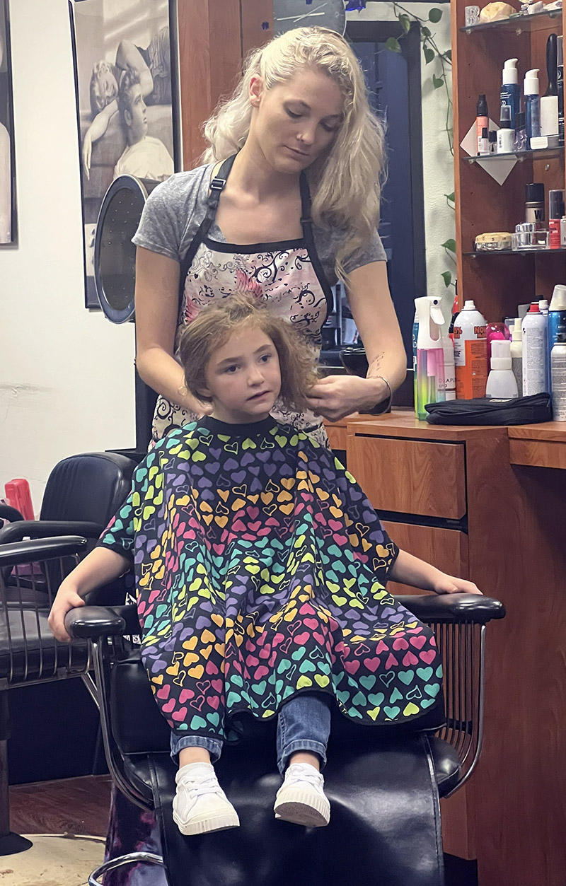 Hair Affair woman cutting hair